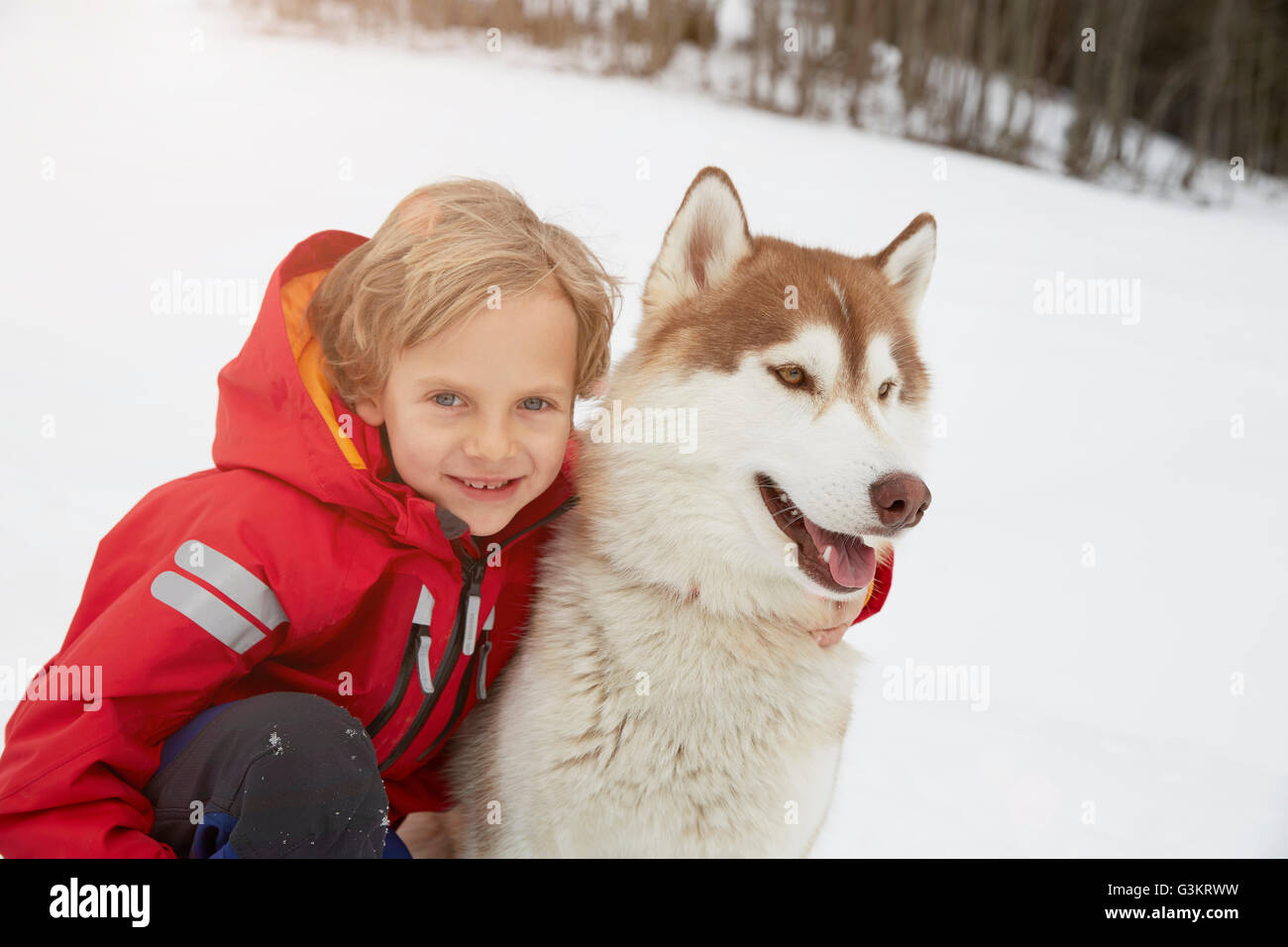 Portrait of boy and husky in snow, Elmau, Bavaria, Germany Stock Photo