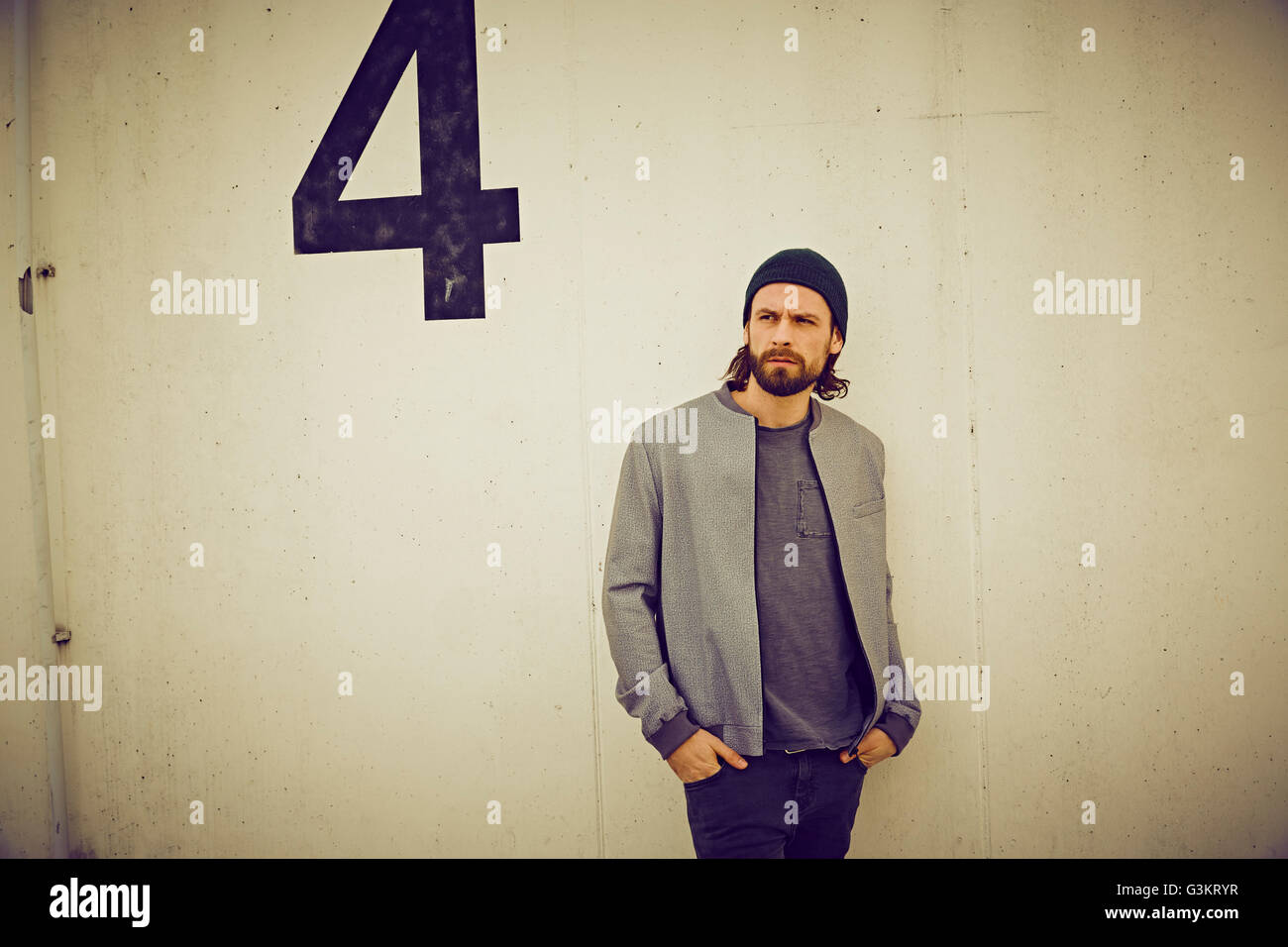 Cool mid adult man leaning against wall number four Stock Photo