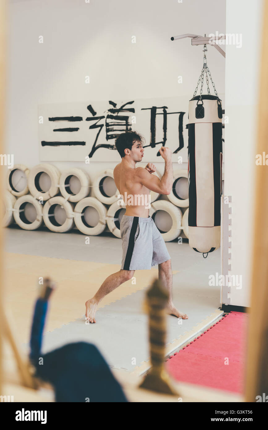 Martial artist in gym sparring with punchbag Stock Photo Alamy