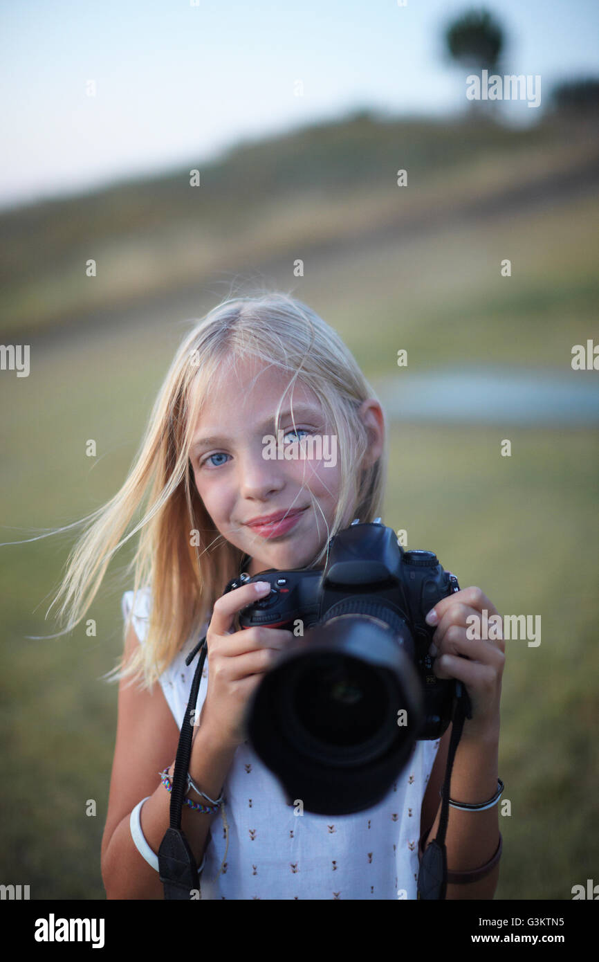Portrait of girl photographing with digital slr, Buonconvento, Tuscany, Italy Stock Photo