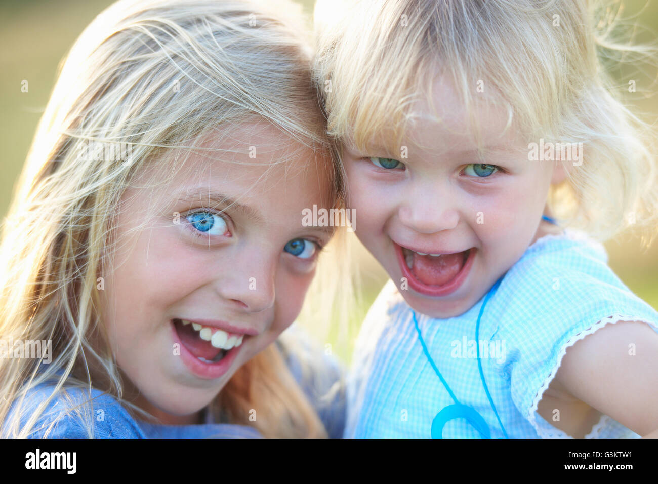 Portrait of two young sisters, outdoors, smiling Stock Photo