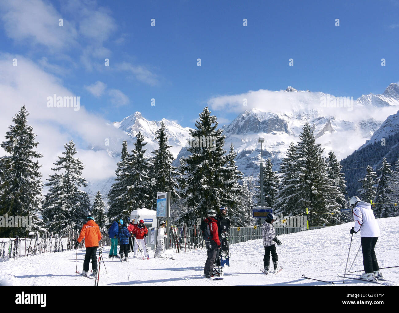 Skiers waiting for the train at Brandegg, Switzerland Stock Photo