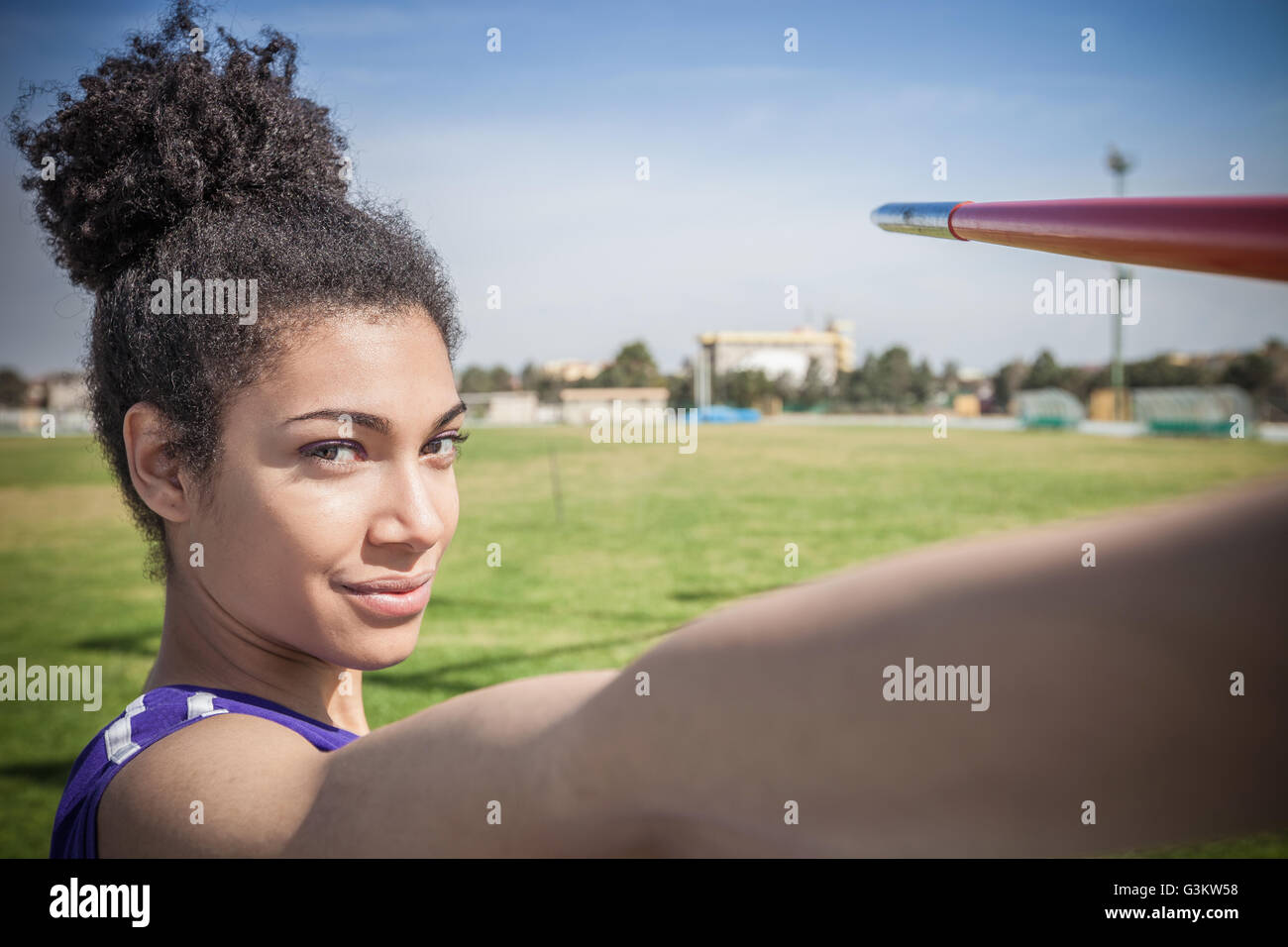 Portrait of young female javelin thrower in sports ground Stock Photo