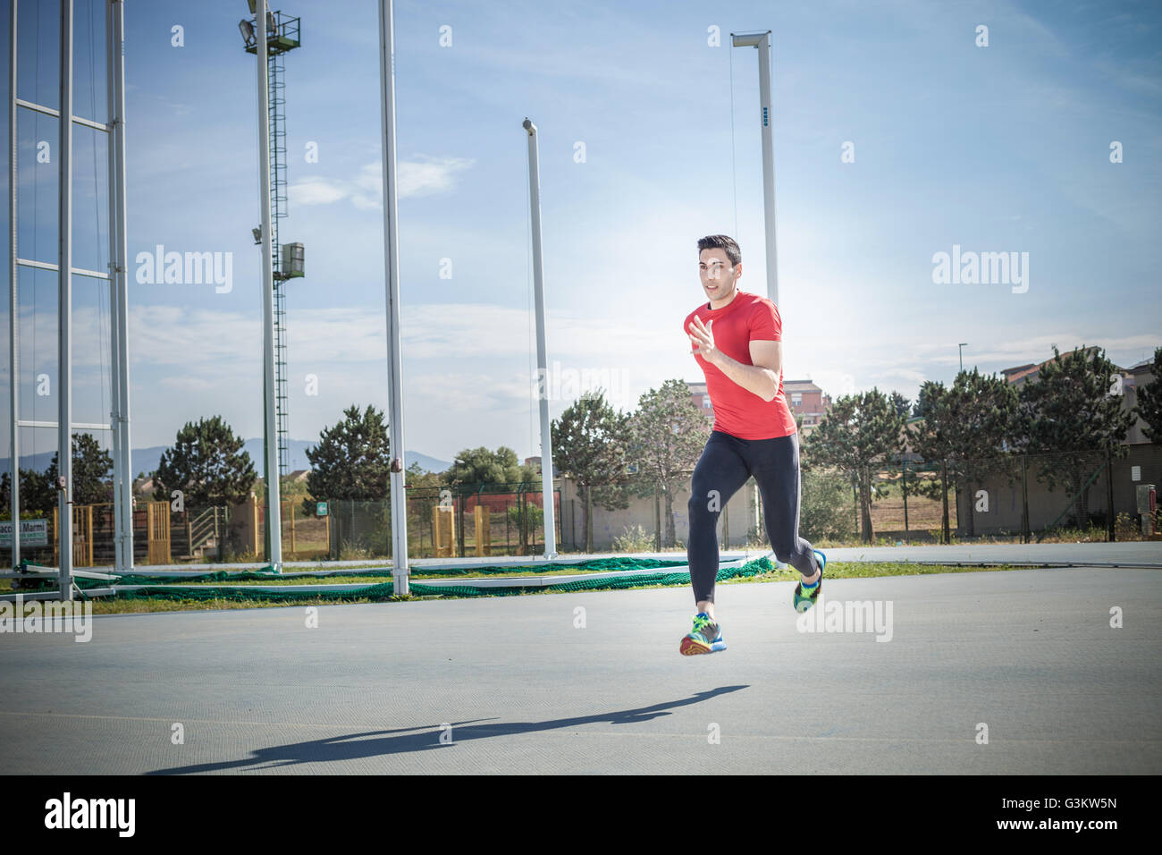 Young male sprinter sprinting at sport facility Stock Photo