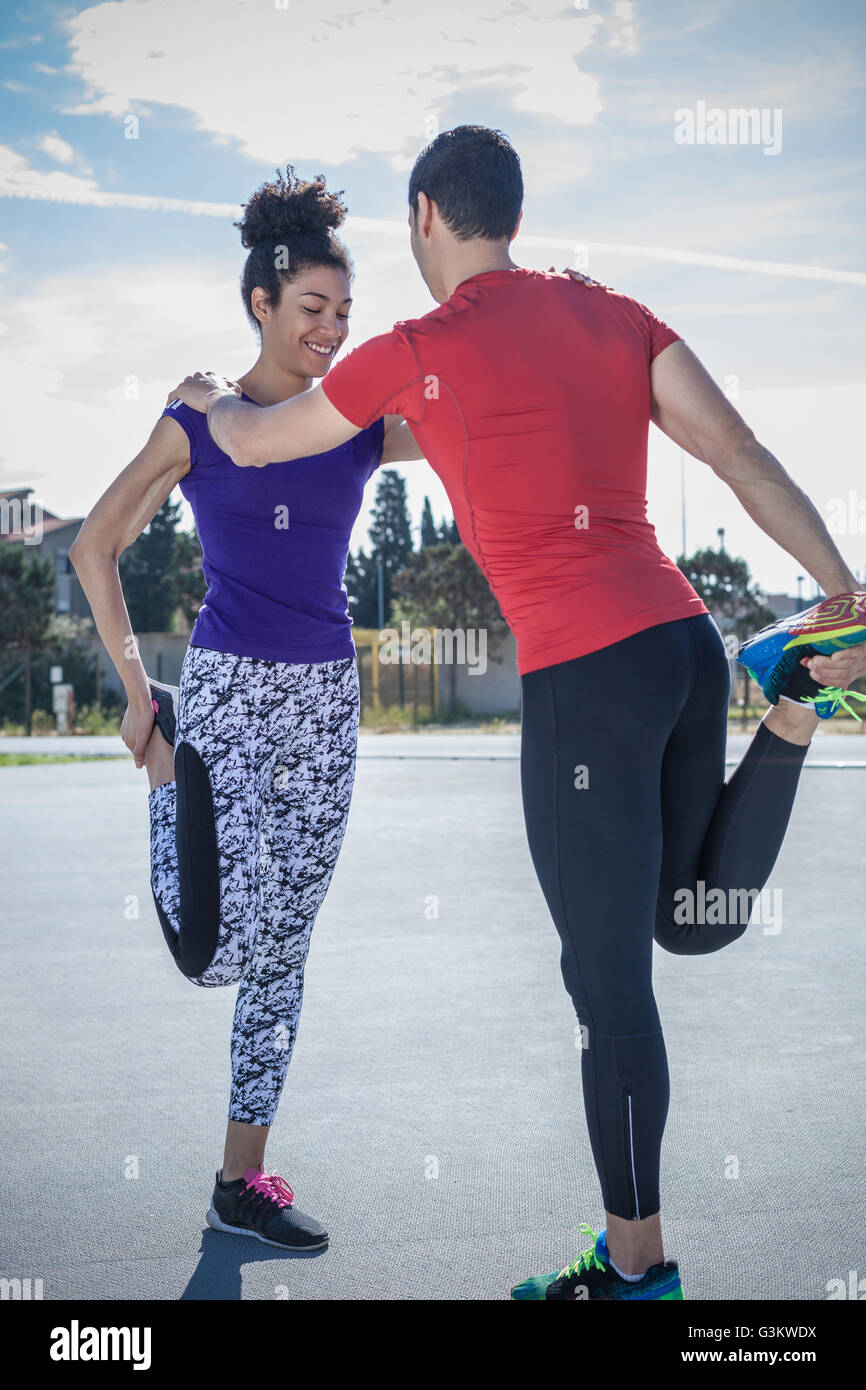 Young man and woman training together at sport facility Stock Photo