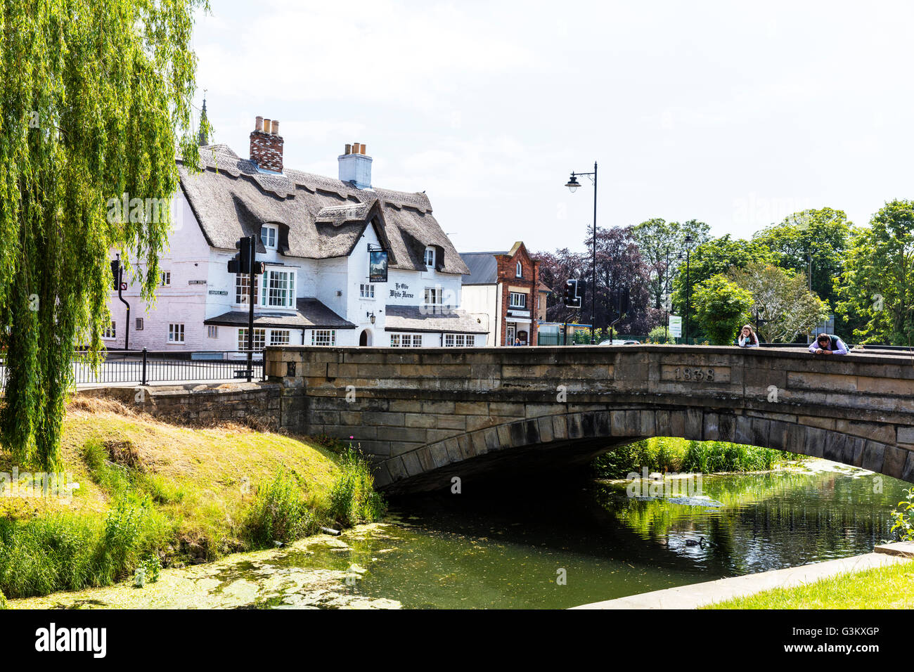 People looking over bridge at river Welland Spalding town Lincolnshire UK England English rivers towns Stock Photo