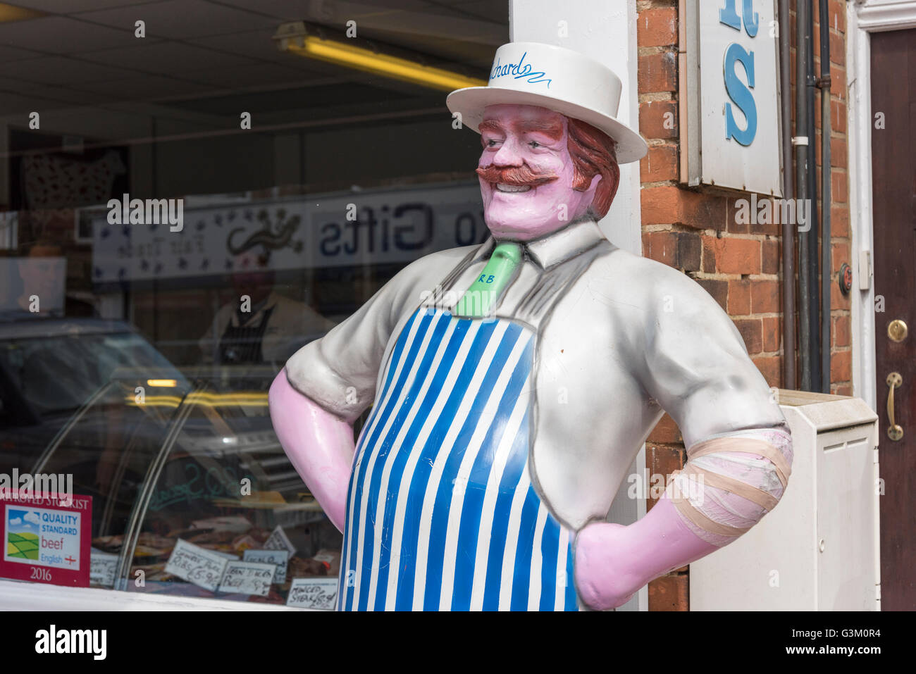 A model of a butcher outside a butchers shop in Hunstanton UK Stock Photo