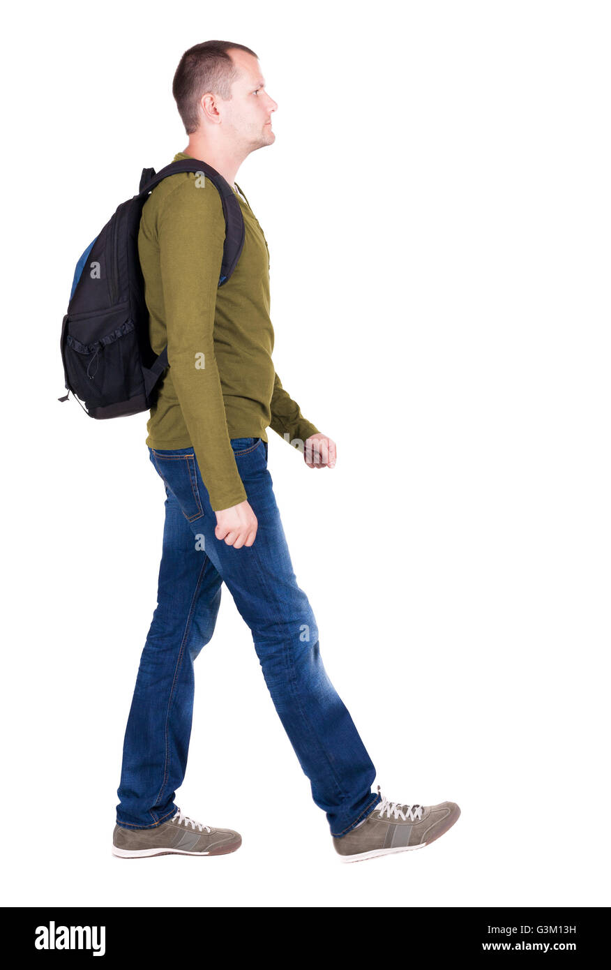 back view of walking man with backpack. brunette guy in motion. backside view of person. Rear view people collection. Isolated over white background. young man goes to side of a rolling travel bag on wheels Stock Photo