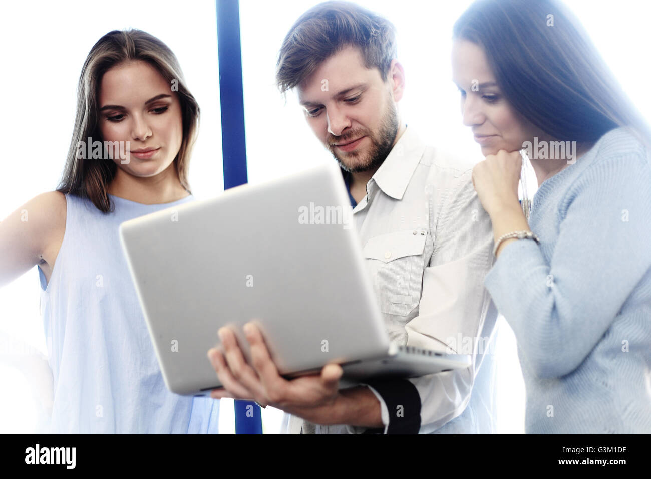 Project manager team discussing new idea.Business crew working with startup. Laptop, showing presentation, monitor.Blurred,film effect. Stock Photo