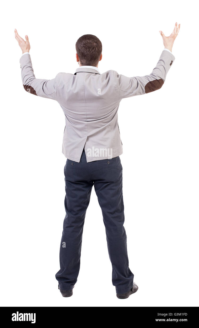 A man in a jacket raised his hands in prayer. Standing young man. Rear ...