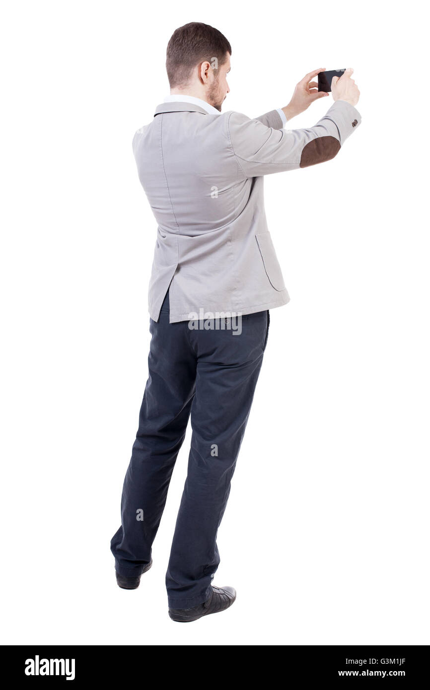 back view of business man on phone photographs. rear view people collection. Isolated over white background. backside view of person. A bearded man in a suit photographed telephone. Stock Photo