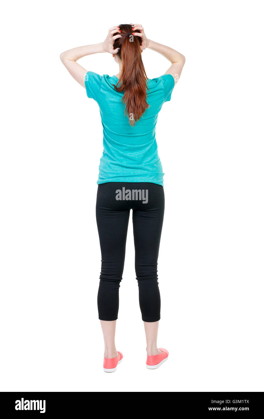 Back view of shocked woman. upset young girl. Rear view people collection. backside view of person. Isolated over white background. Sports girl clutching her hands behind her head. Stock Photo