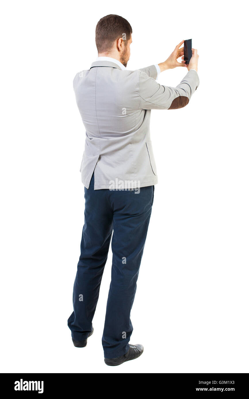 back view of business man on phone photographs. rear view people collection. Isolated over white background. backside view of person. guy worth photographing everything around him. Stock Photo