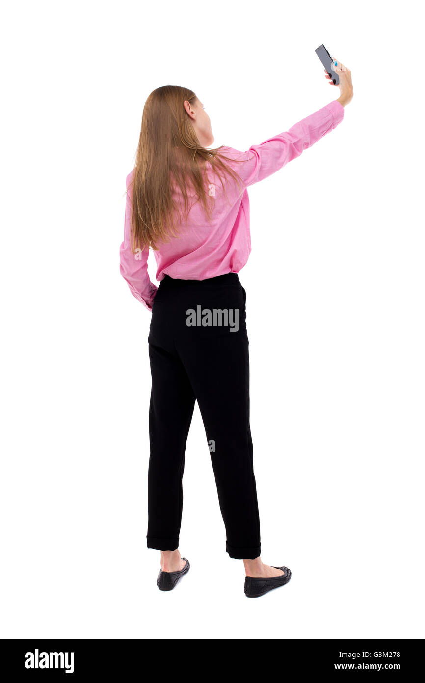 back view of standing young beautiful woman and using a mobile phone ...