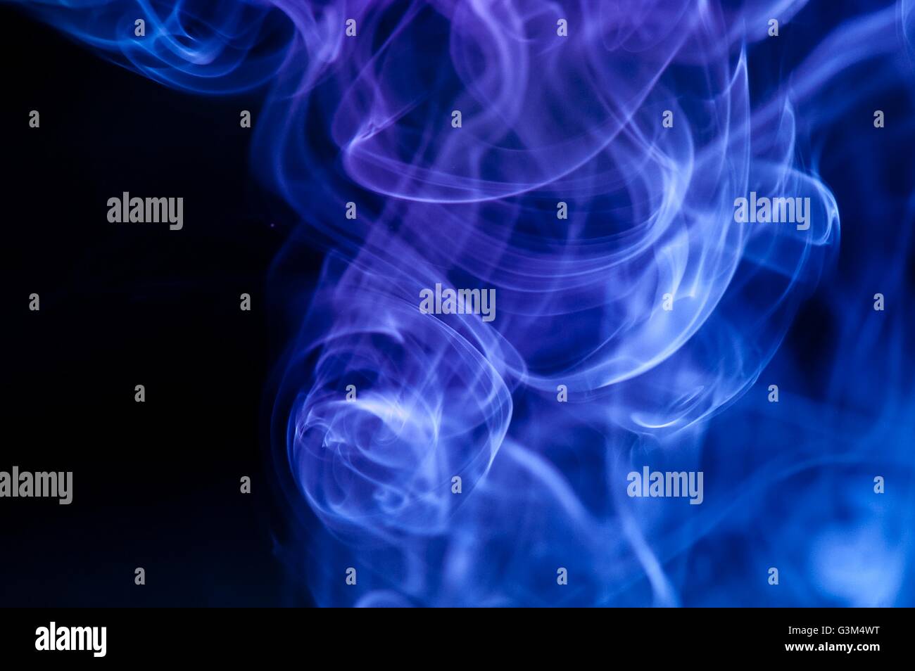 abstract blue smoke over black background Stock Photo - Alamy