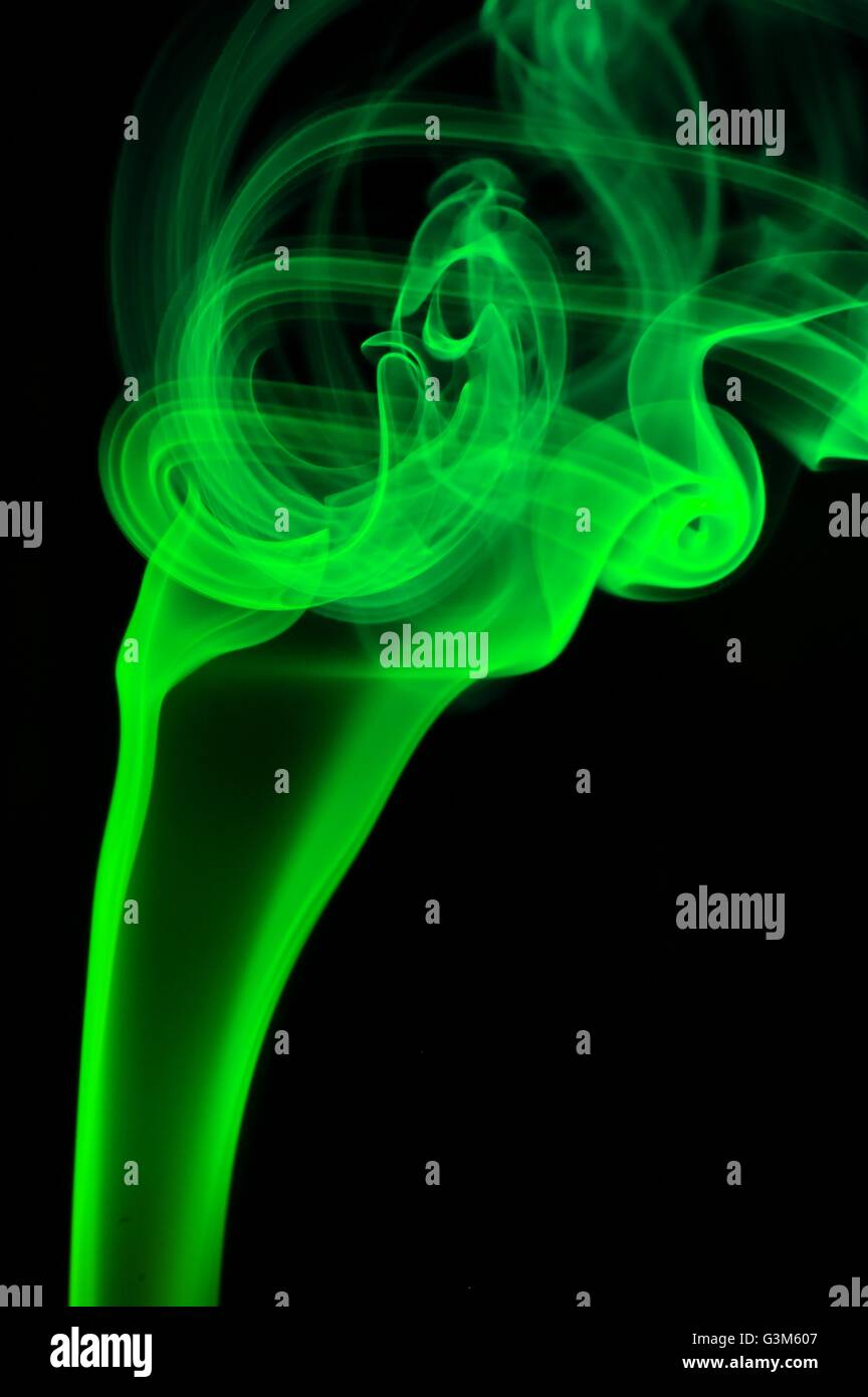 Abstract green smoke over black background Stock Photo - Alamy