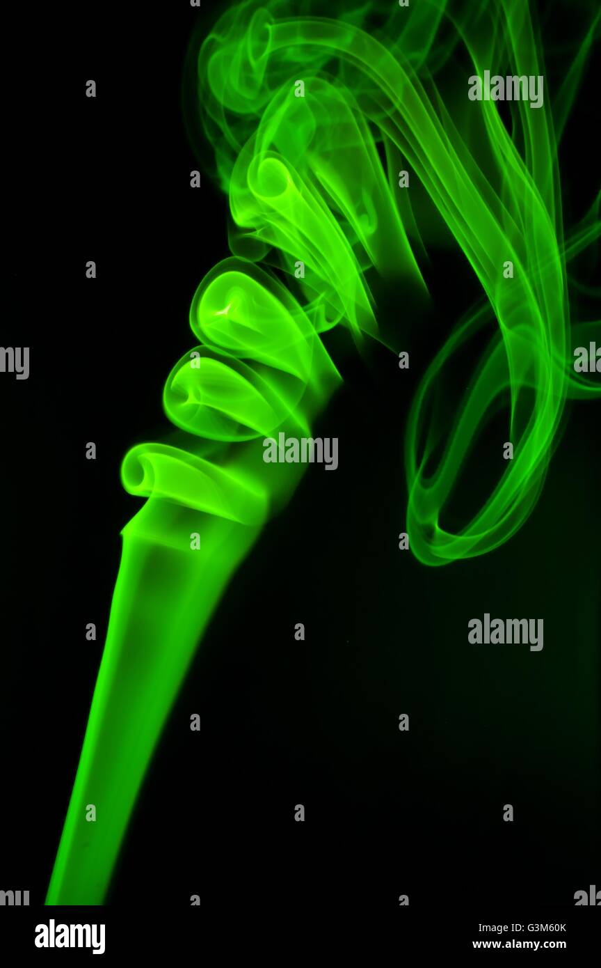 Abstract green smoke over black background Stock Photo - Alamy