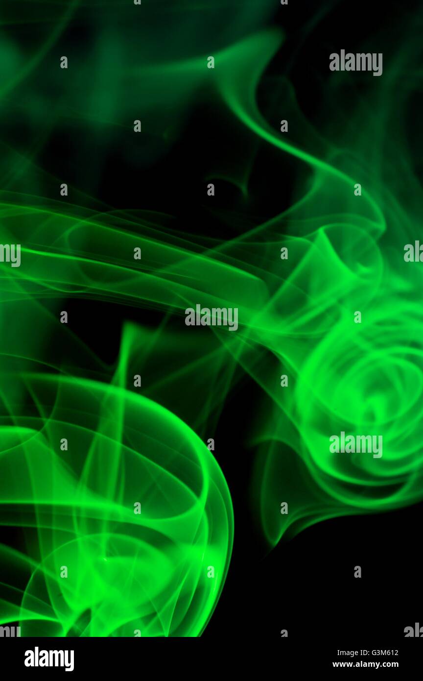Abstract green smoke over black background Stock Photo - Alamy