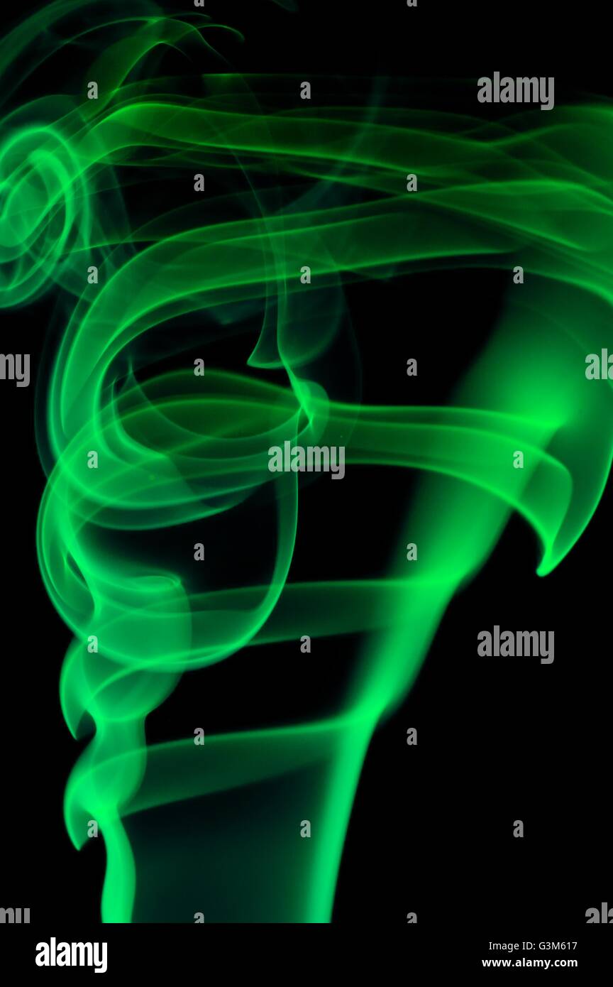 Abstract green smoke over black background Stock Photo - Alamy
