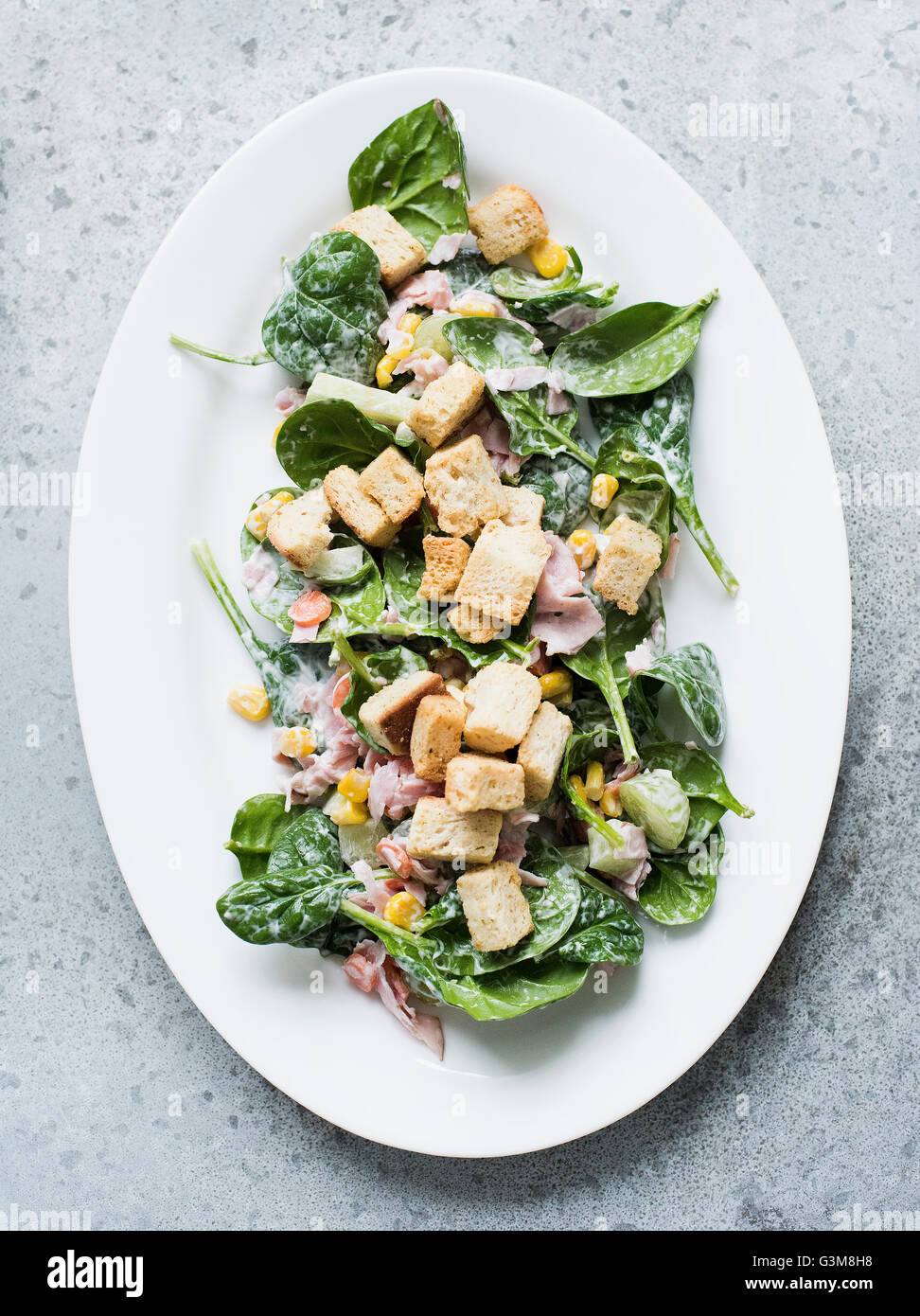 Spinach salad with ham and focaccia crouton Stock Photo