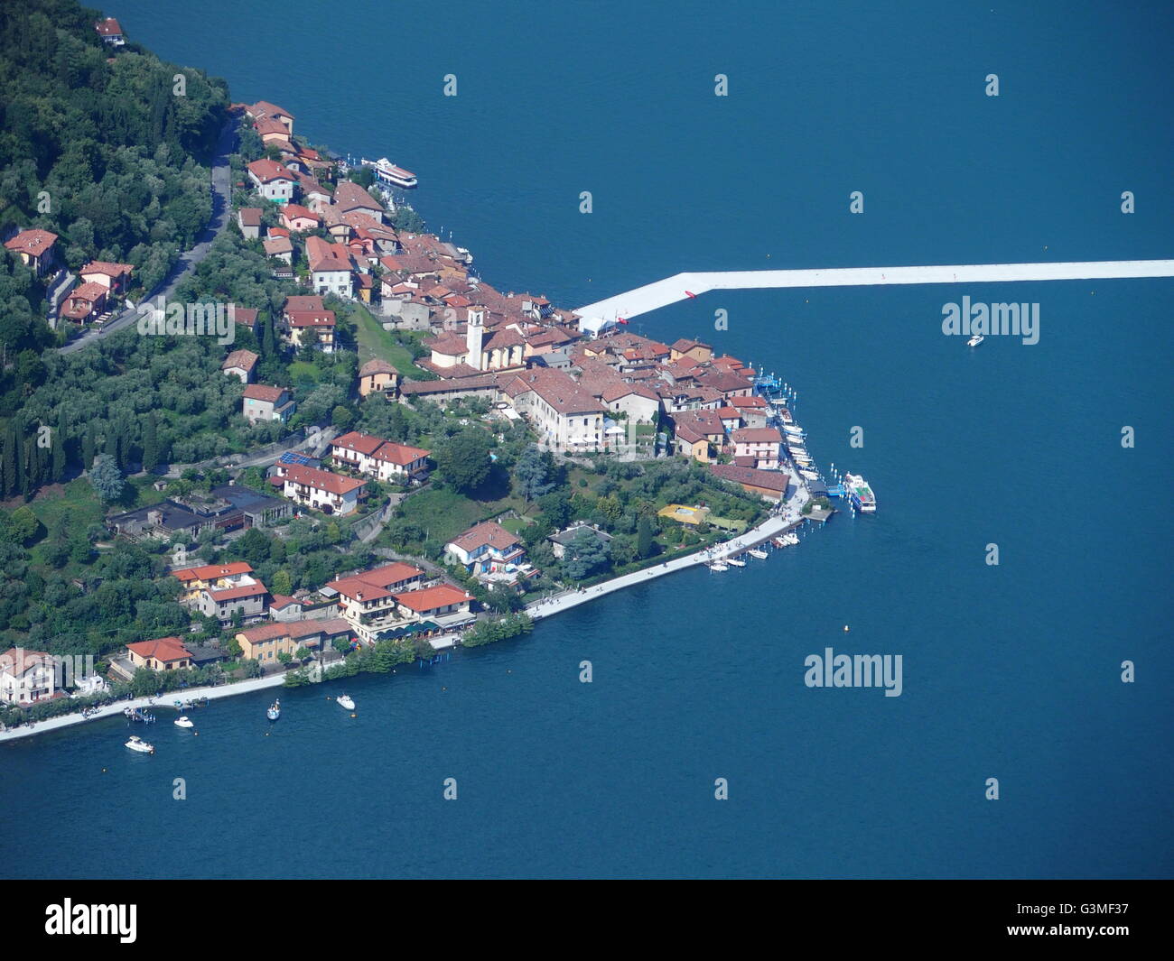 Iseo Lake, Italy. 12th June, 2016. Aerial view of Christo's "The Floating piers" project are now completed but not yet accessed by people. The piers are made up of floating polyethylene cubes and covered with fabric creating the walkways. Riccardo Mottola/Alamy Live News Stock Photo