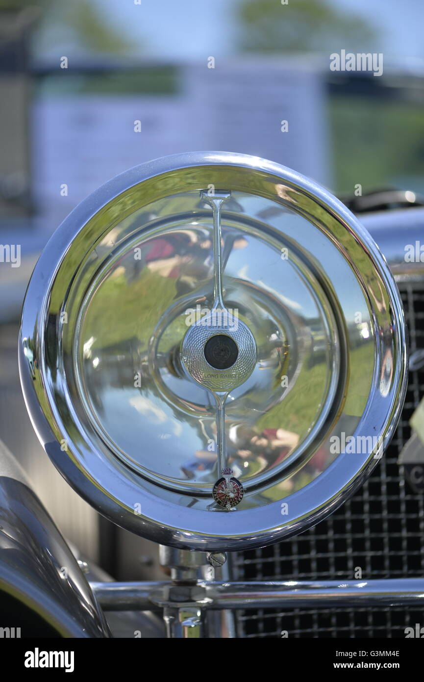 Westbury, New York, USA. June 12, 2016.  Round chrome Bi-flex Long Range Headlamp, with Lucas Prince of Darkness Badge, close up of 1973 Intermeccanica Squire SS-100 Italian luxury classic roadster, owned by Mark Offenberg of Valley Stream, which won 3rd Place Trophy in the foreign car category at the Antique and Collectible Auto Show at the 50th Annual Spring Meet at Old Westbury Gardens, in the Gold Coast of Long Island, and sponsored by Greater New York Region, GNYR, Antique Automobile Club of America, AACA. Car is the 46th of only 50 Intermeccanica's coachbuilt in Turin, Italy. Stock Photo