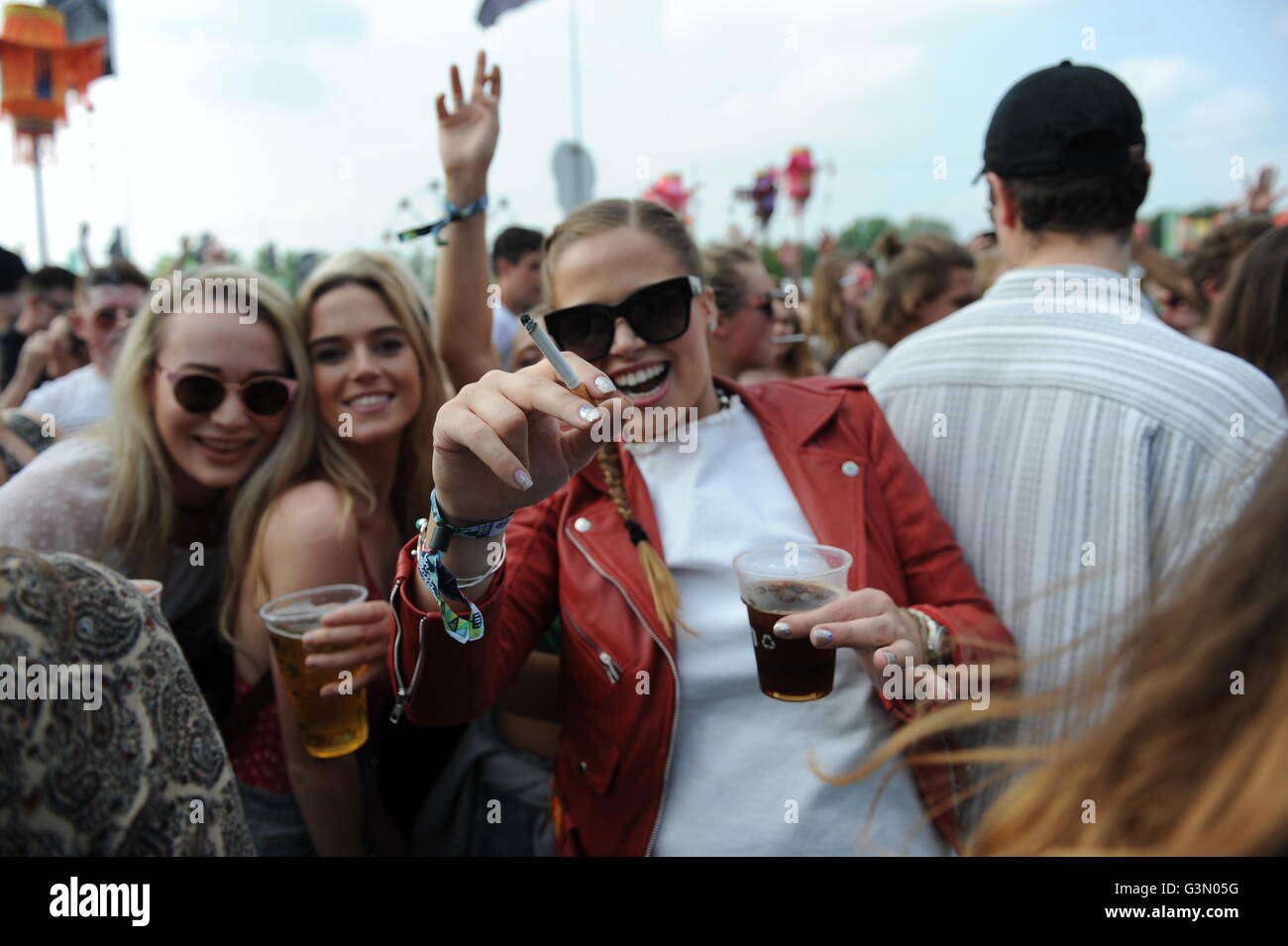 Group of Teenage girls drinking and smoking at music festival in Oxford, UK Stock Photo