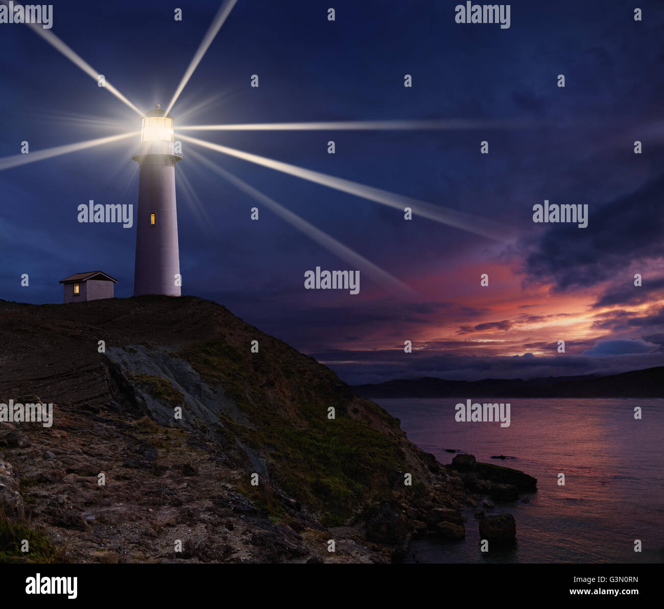 Lighthouse on the island against night sky Stock Photo