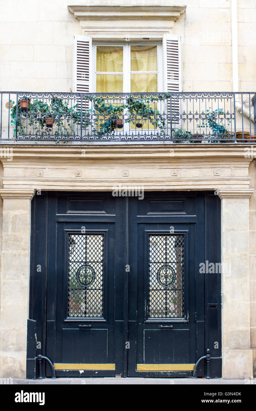 View of the door and a terrace of an old building in Paris Stock Photo
