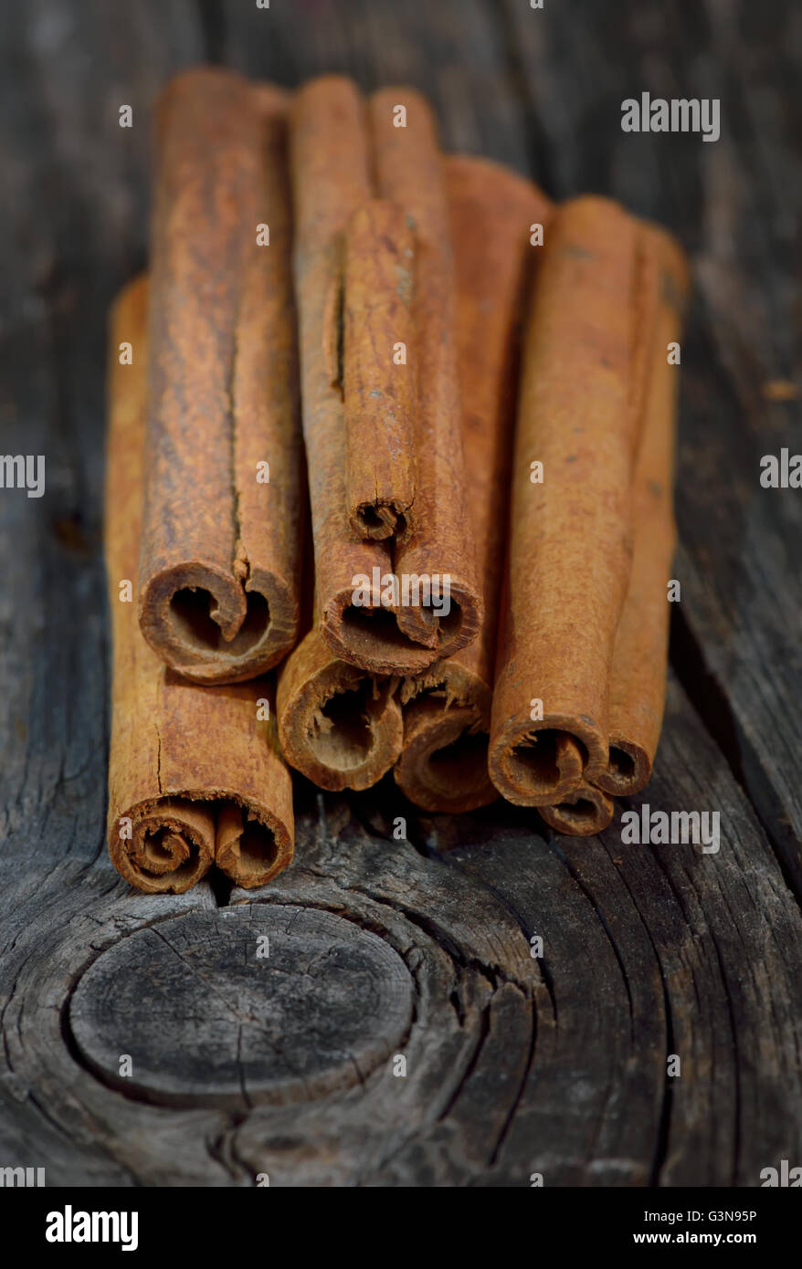 Bunch of cinnamon sticks on wooden table Stock Photo
