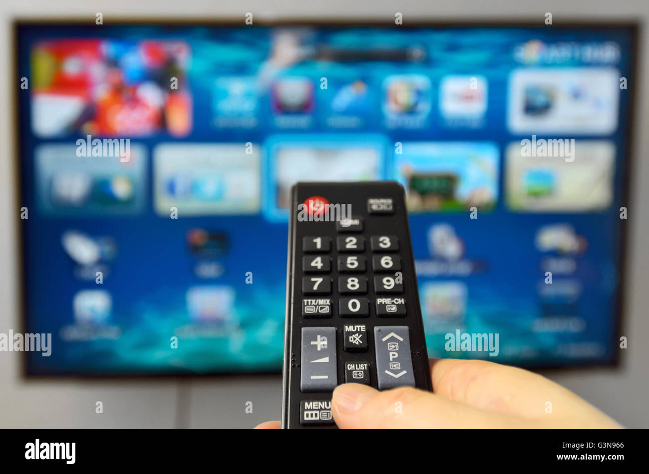 Smart tv and hand hold the remote control Stock Photo