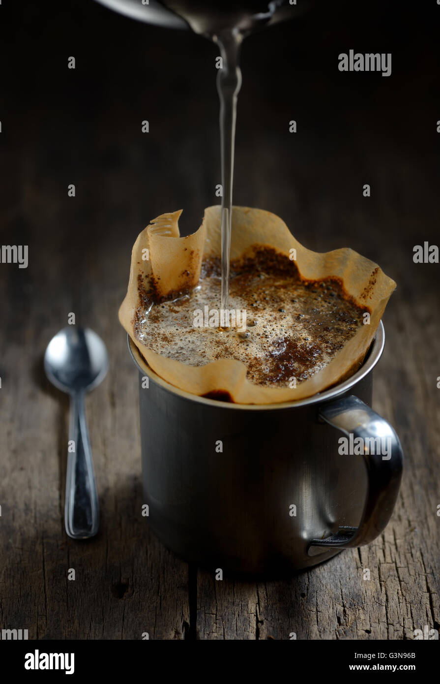 Ground coffee in metal cup and filter holder Stock Photo Alamy