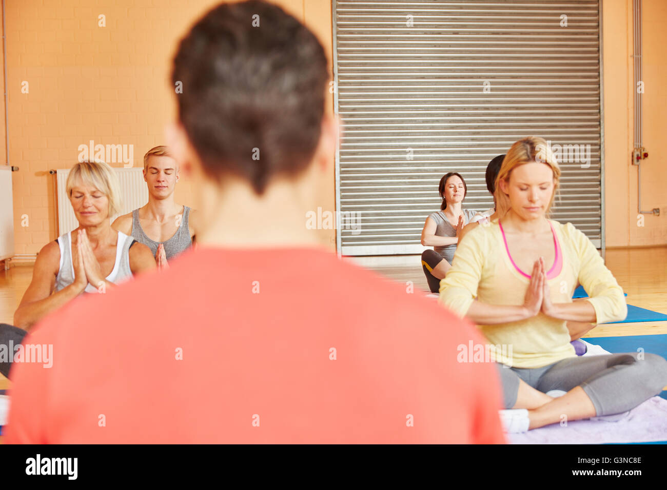 Yoga class at fitness center during a breathing exercise at health club Stock Photo