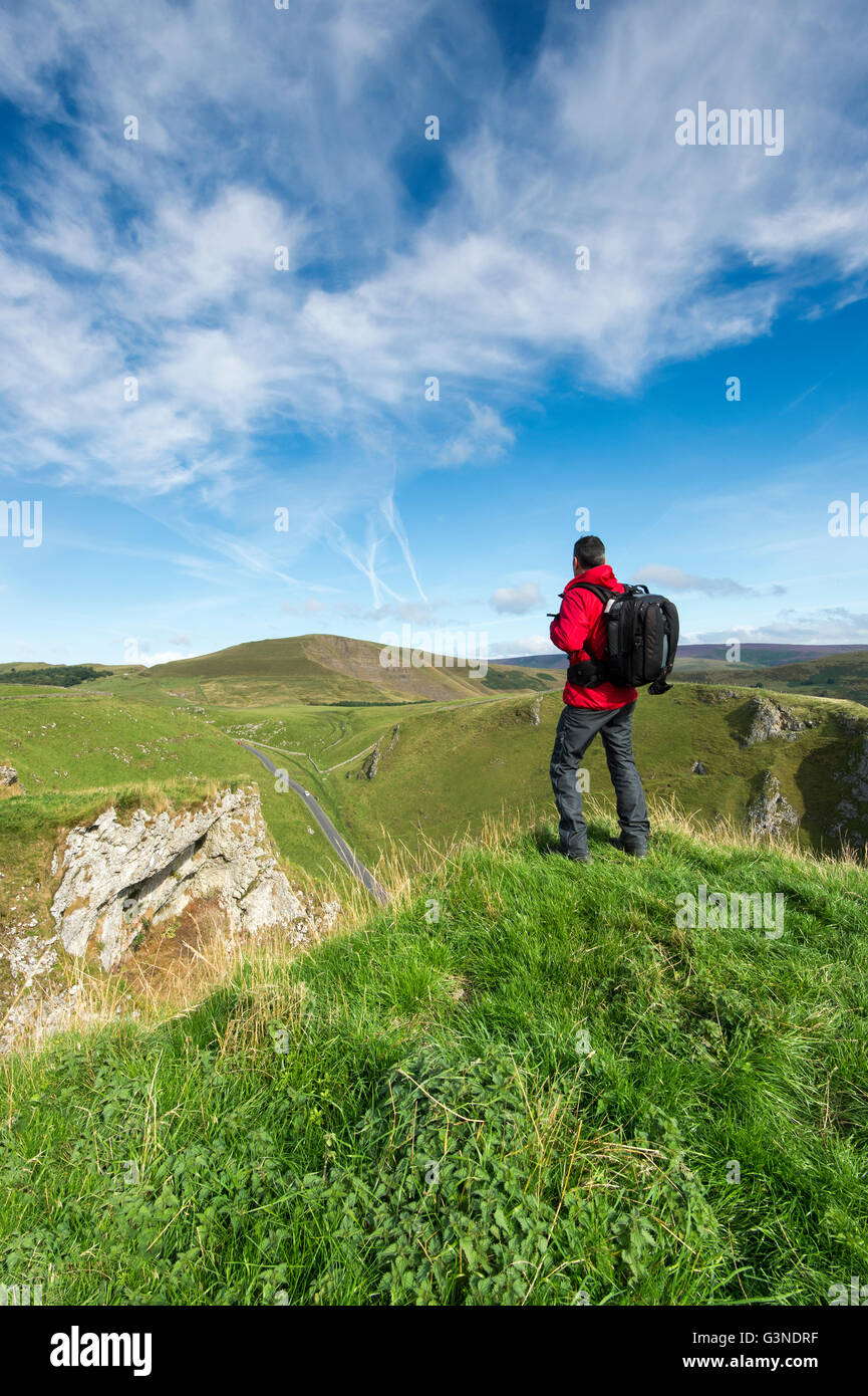 A Walker looking towards Mam Tor, The Great Ridge and the Edale Valley, Derbyshire, UK Stock Photo