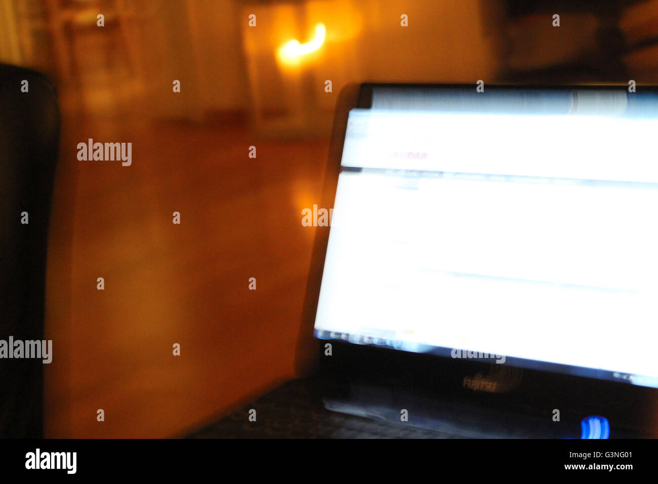 Computer screen with light in background, moving camera and blurred Stock Photo