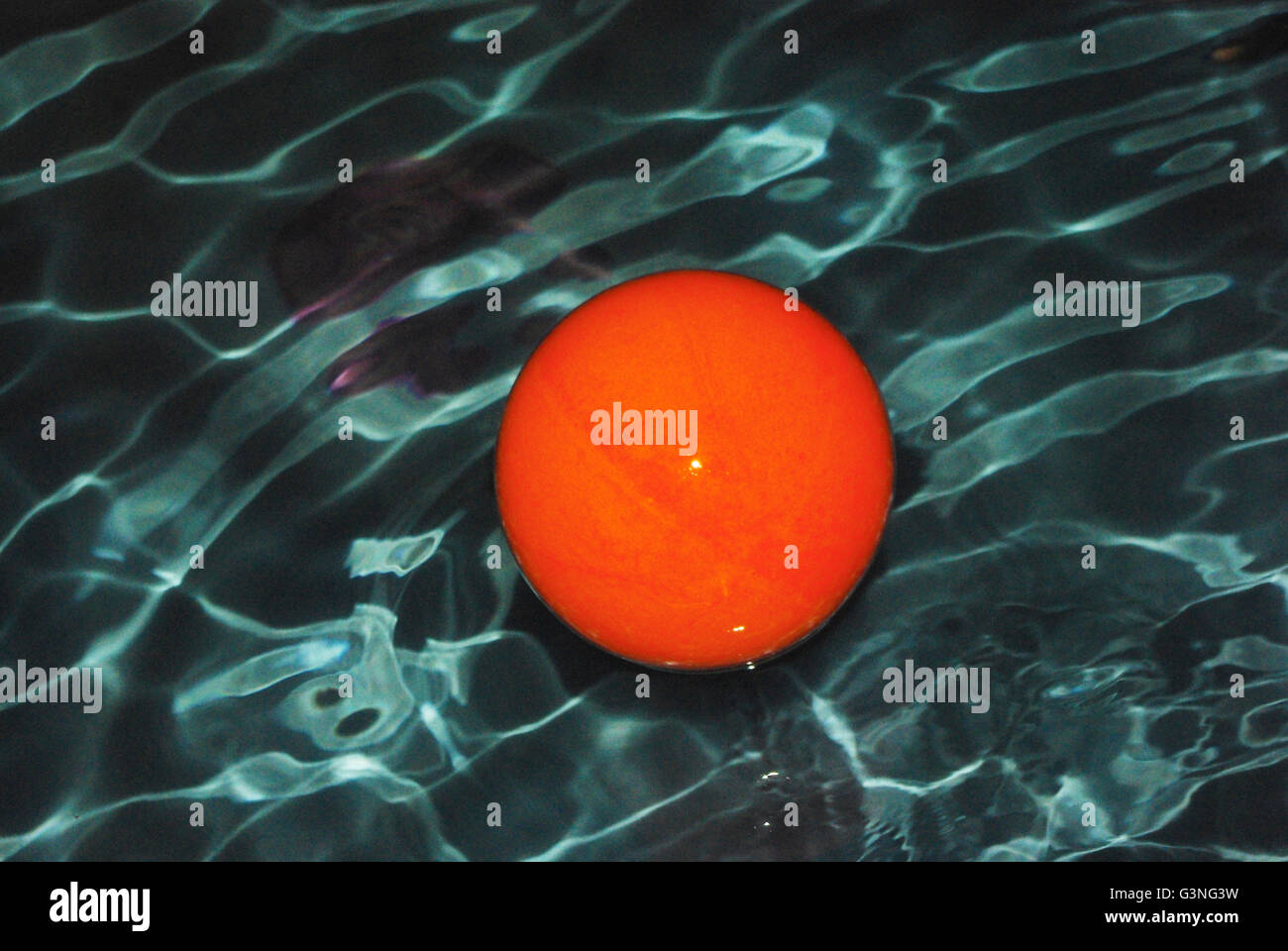 Orange ball in pool Stock Photo Alamy