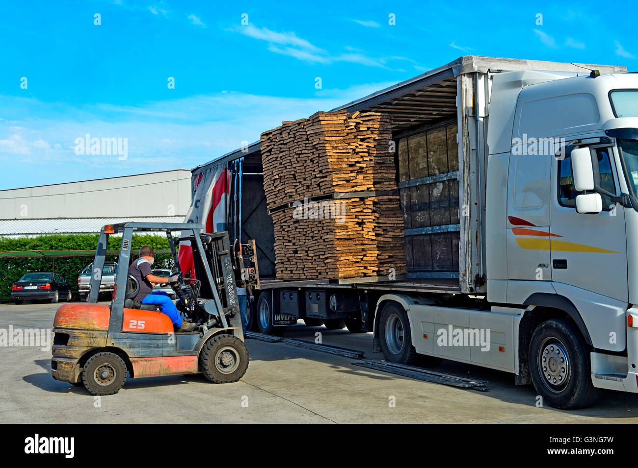A forklift uploads pallets of graded cork on a truck, cork factory