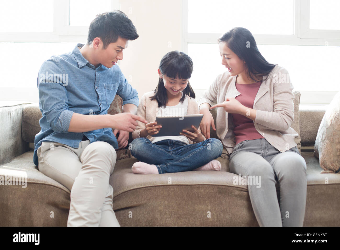 Young parents scolding their daughter Stock Photo