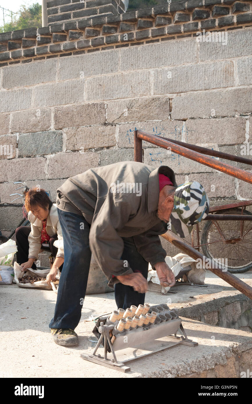 Chinese man loading fireworks on National Day, Great Wall of China at