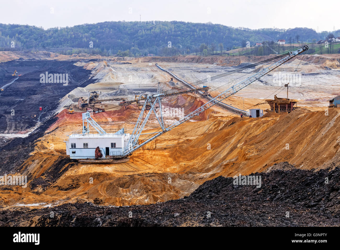 open coal mining pit with heavy machinery Stock Photo - Alamy