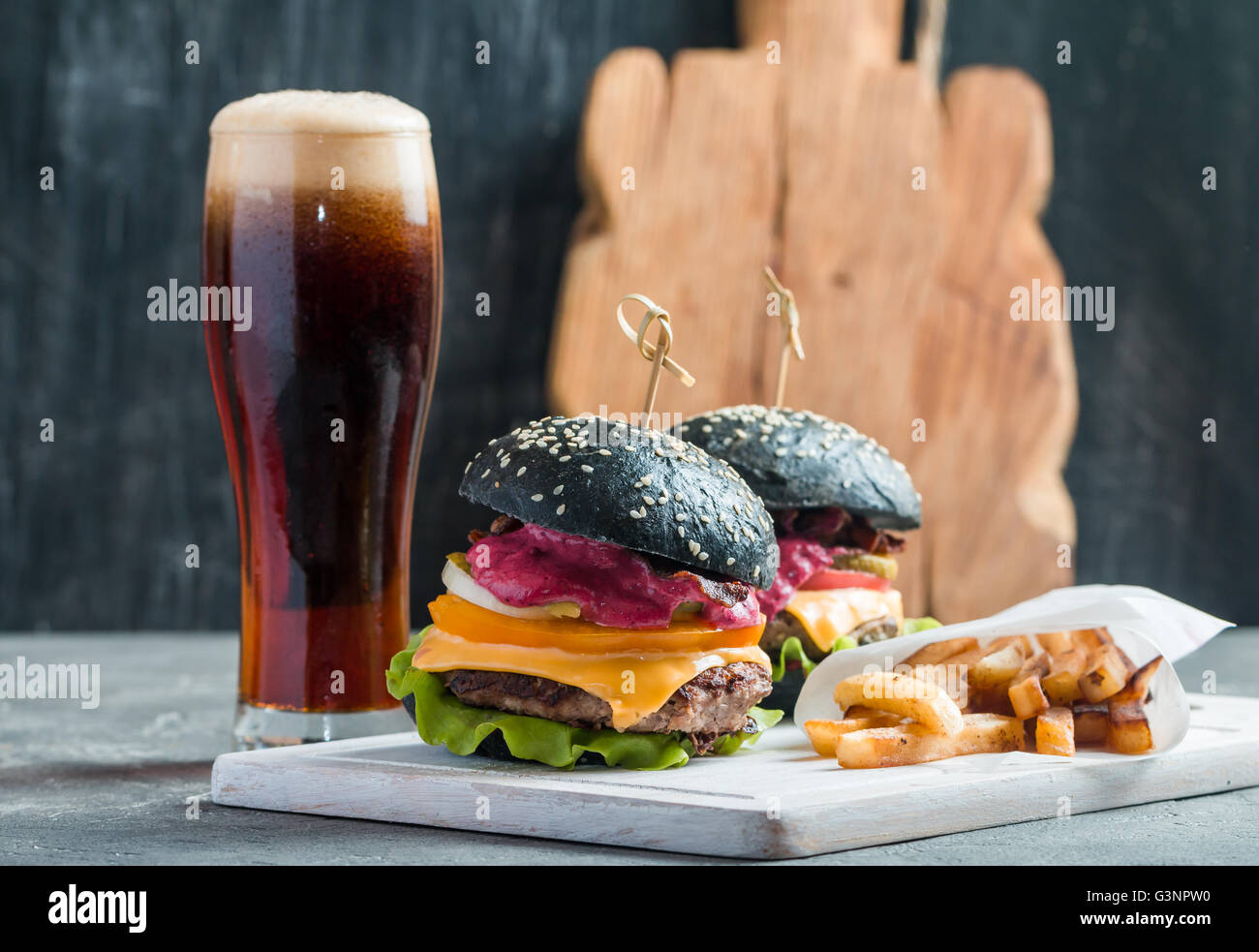 Homemade burger with black bun Stock Photo