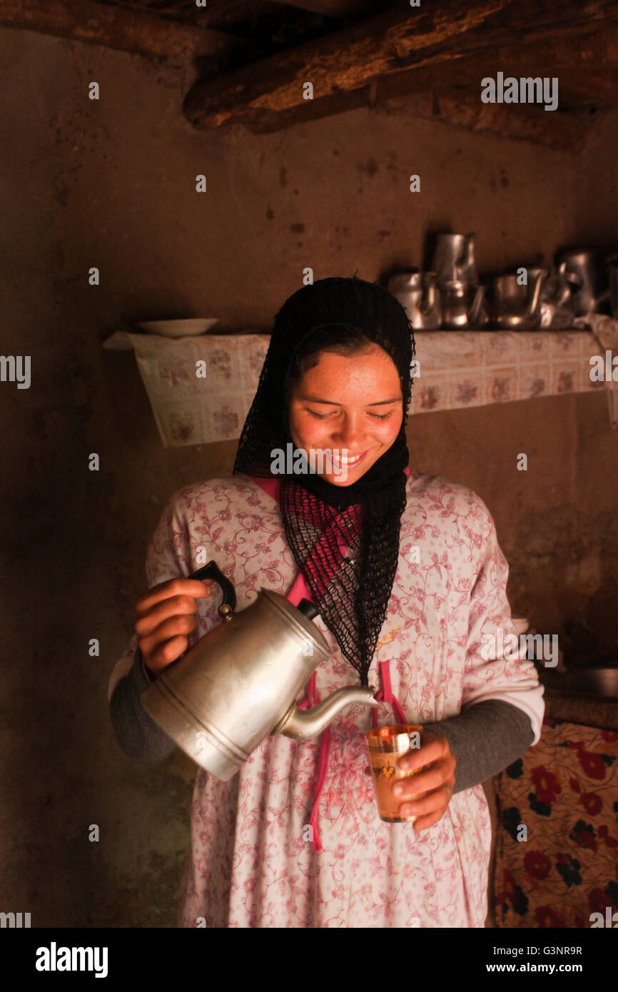 Berber teenaged girl pouring mint tea; Ait Souka Village, High Atlas Mountains, Morocco Stock Photo