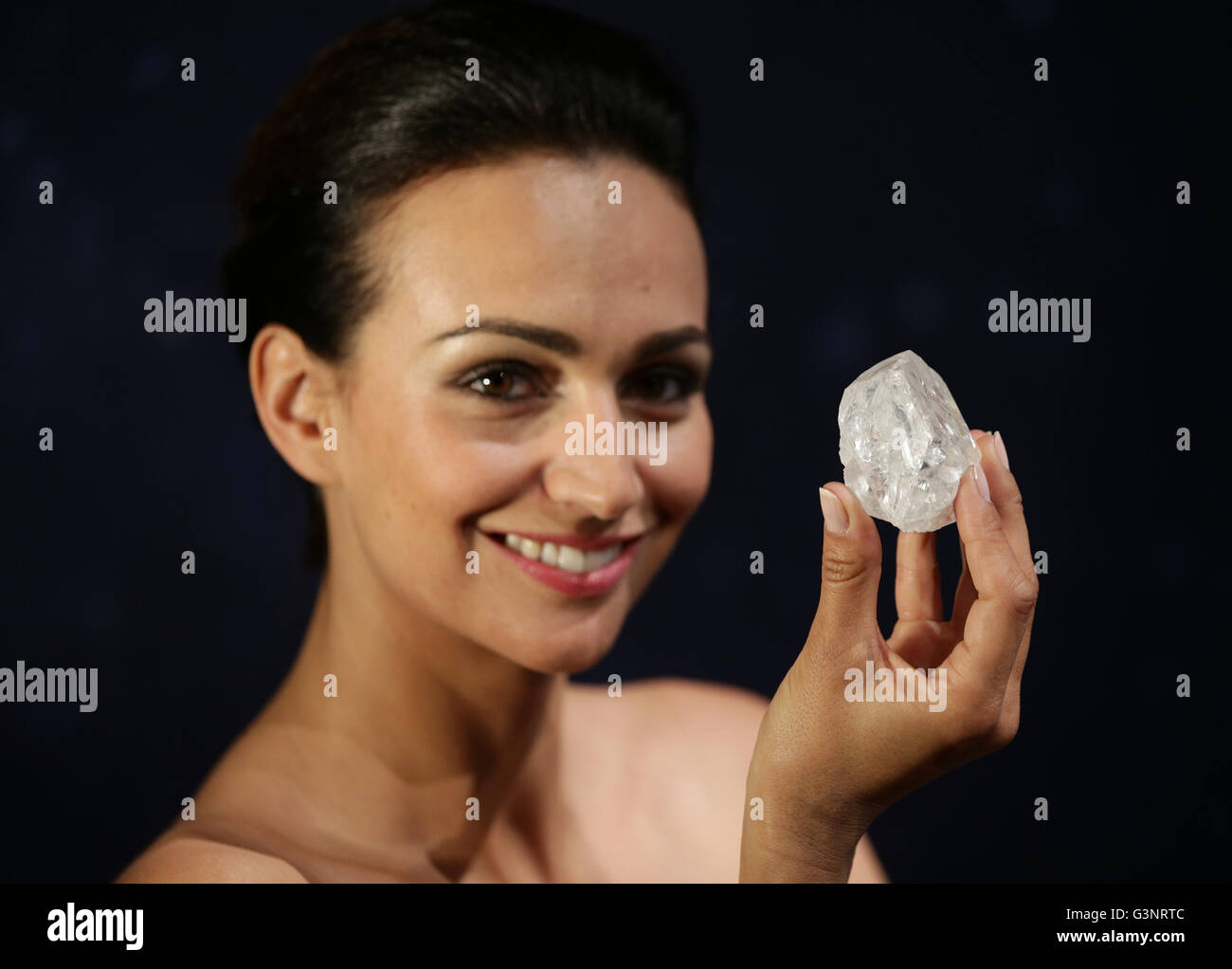 Model Stephanie Sinnah holds Lesedi la Rona: a 1,109-carat rough