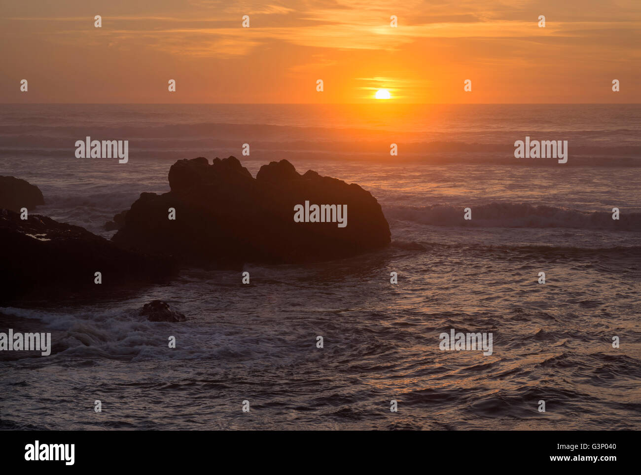 USA, Oregon, Yachats, Sunset over basalt sea stacks. Stock Photo