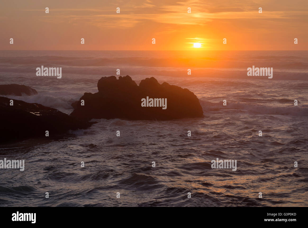 USA, Oregon, Yachats, Sunset over basalt sea stacks. Stock Photo