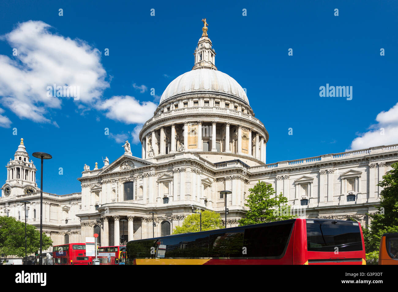 St Paul's Cathedral in London with red buses, with blue sky and white cloud Stock Photo