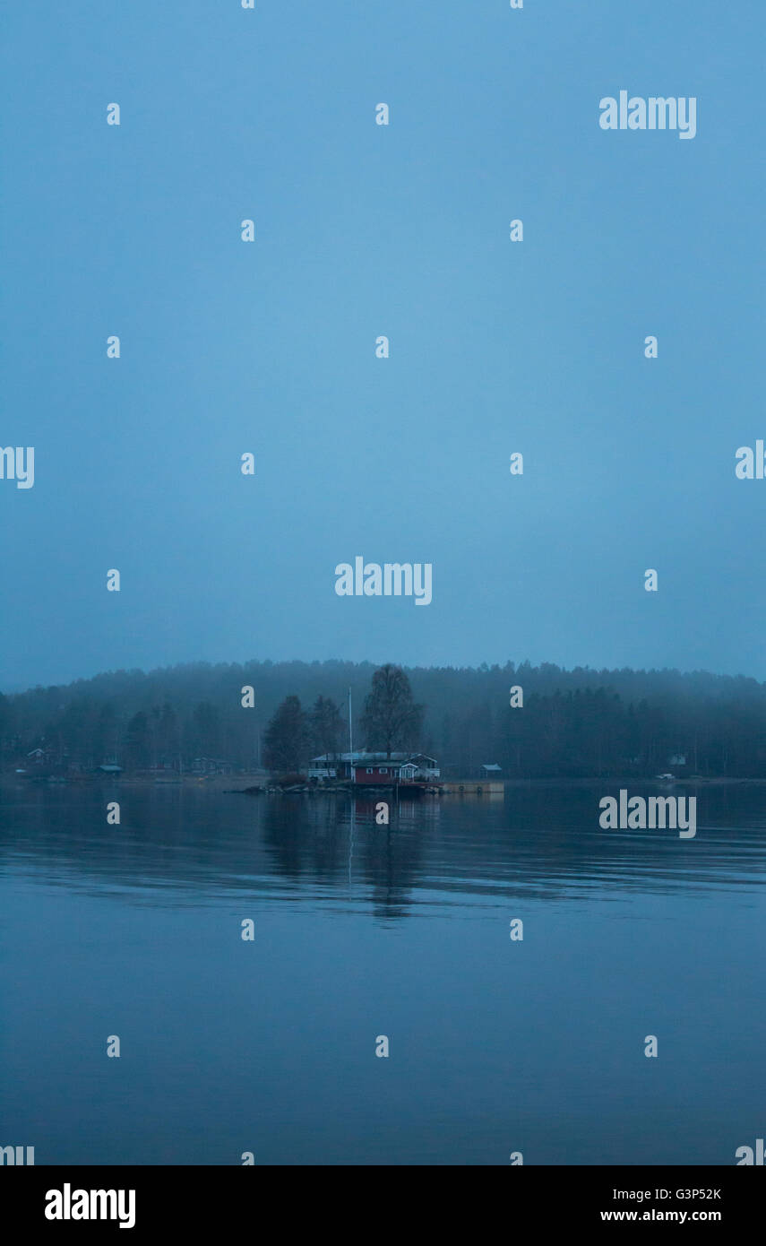 Sweden, Medelpad, Juniskar, View of riverbank in fog Stock Photo