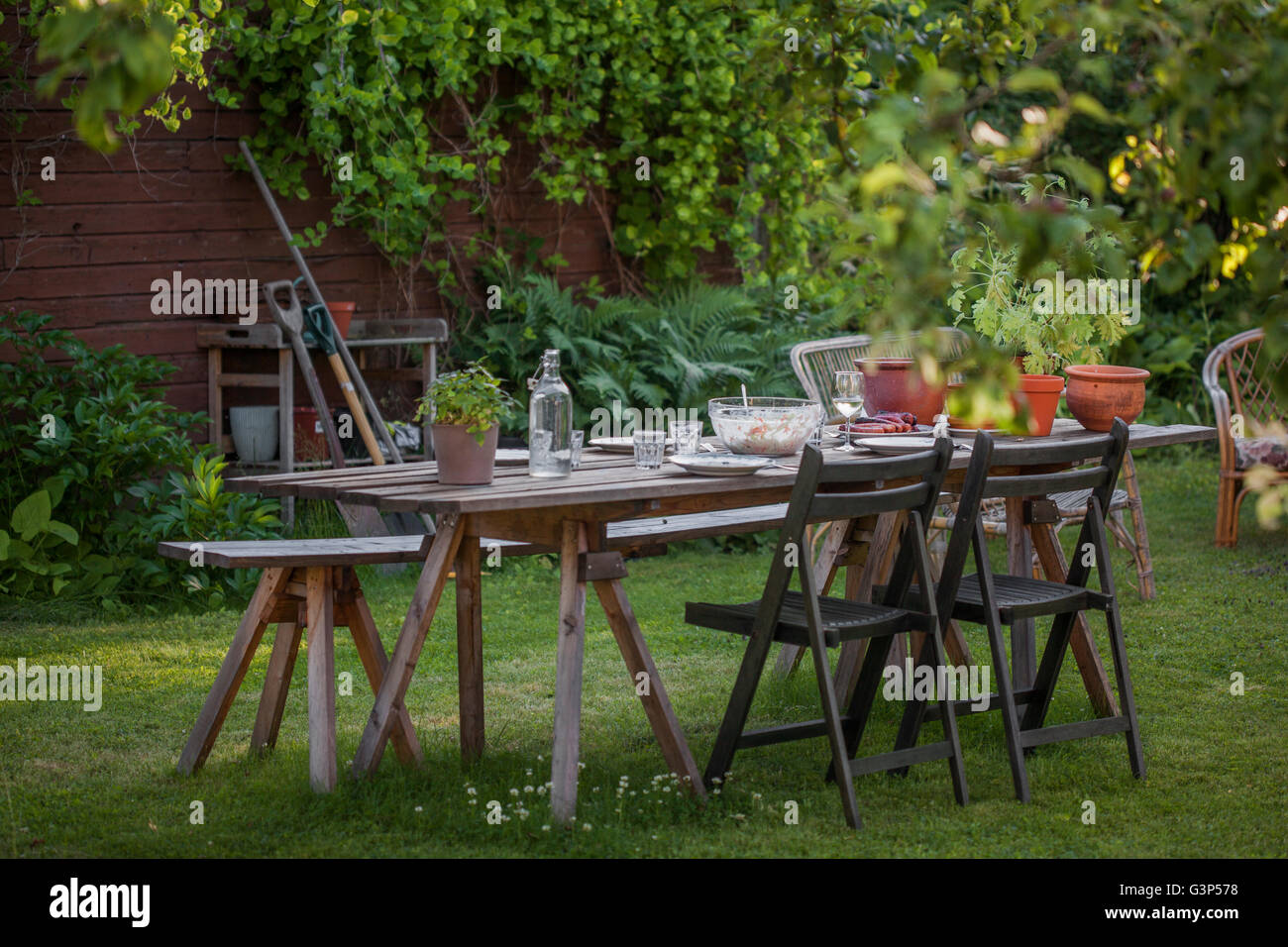 Sweden, Dining table in garden Stock Photo Alamy
