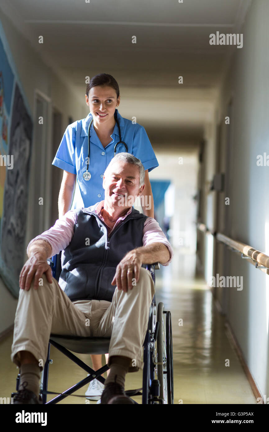 Portrait of patient in a wheelchair pushing by a nurse Stock Photo Alamy