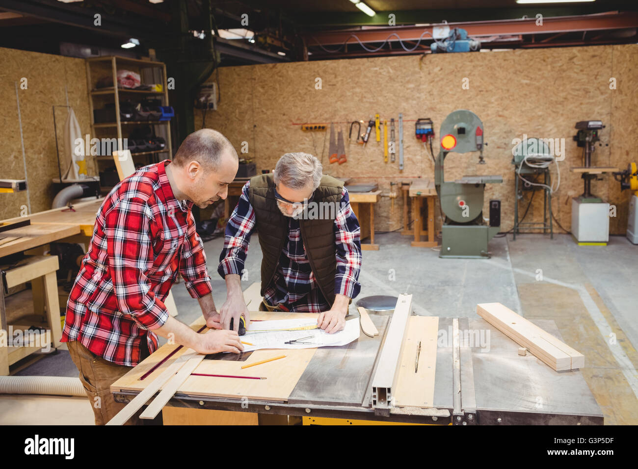 Carpenters reading a work plan Stock Photo Alamy
